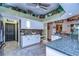 Modern kitchen with white cabinets, granite countertops, and a breakfast bar at 8345 Shenandoah Run, Wesley Chapel, FL 33544