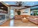 Cozy living room features a stone fireplace and hardwood floors at 8345 Shenandoah Run, Wesley Chapel, FL 33544