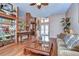 Comfortable living room with hardwood floors and access to entryway at 8345 Shenandoah Run, Wesley Chapel, FL 33544