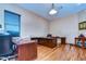 Home office with built-in desk and hardwood floors at 8345 Shenandoah Run, Wesley Chapel, FL 33544