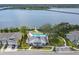 Aerial view of waterfront community with pool, clubhouse, and dock at 1003 Starboard Ct, Oldsmar, FL 34677