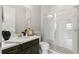 Bathroom with single vanity, a shower, and dark brown cabinets at 1003 Starboard Ct, Oldsmar, FL 34677