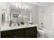 Bathroom with double vanity, dark brown cabinets, and a bathtub at 1003 Starboard Ct, Oldsmar, FL 34677