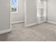 Bright bedroom with carpet flooring, a window, and access to a closet at 1003 Starboard Ct, Oldsmar, FL 34677