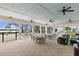 Covered patio with tables and chairs near the pool at 1003 Starboard Ct, Oldsmar, FL 34677