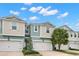 Two-story townhome with two-car garage and landscaping at 1003 Starboard Ct, Oldsmar, FL 34677