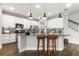 Modern kitchen with white cabinets, granite counters and island at 1003 Starboard Ct, Oldsmar, FL 34677