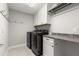 Laundry room with washer, dryer, cabinets, and a granite countertop at 1003 Starboard Ct, Oldsmar, FL 34677