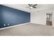 Main bedroom with blue accent wall and ceiling fan at 1003 Starboard Ct, Oldsmar, FL 34677