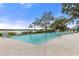 Community pool with water feature and lounge chairs at 1003 Starboard Ct, Oldsmar, FL 34677