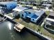 Aerial view of the home and dock, showcasing canal-side location at 13304 Neptune Dr, Hudson, FL 34667