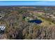 Wide aerial view of property showing house, pond and land at 18409 Tyler Rd, Odessa, FL 33556
