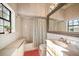Bathroom with shower/tub combo, vanity, and large mirror at 18409 Tyler Rd, Odessa, FL 33556