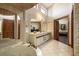 Large bathroom with double vanity, soaking tub, and view into bedroom at 18409 Tyler Rd, Odessa, FL 33556