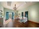 Bright bedroom with hardwood floors, built-in desk, and access to balcony at 18409 Tyler Rd, Odessa, FL 33556