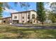 Brick and stucco home with a large yard and paved driveway at 18409 Tyler Rd, Odessa, FL 33556