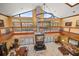 Two-story great room with a large chandelier, fireplace, and balcony at 18409 Tyler Rd, Odessa, FL 33556