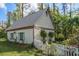 White guest house with metal roof, shutters, and picket fence at 18409 Tyler Rd, Odessa, FL 33556