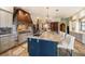 Spacious kitchen boasts a sizable island with granite countertops and a copper range hood at 18409 Tyler Rd, Odessa, FL 33556