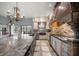Bright kitchen with expansive island, stainless steel appliances, and chic chandelier at 18409 Tyler Rd, Odessa, FL 33556