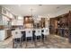 Open kitchen features a large island, wine storage, and brick accent wall at 18409 Tyler Rd, Odessa, FL 33556