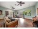 Living room with hardwood floors, large screen TV, and access to balcony at 18409 Tyler Rd, Odessa, FL 33556