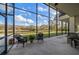 Spacious screened porch overlooking tranquil pond and lush landscape at 18409 Tyler Rd, Odessa, FL 33556