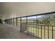 Large screened porch with tiled floor and scenic pond view at 18409 Tyler Rd, Odessa, FL 33556