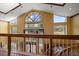 View from upper landing showcasing the home's grand entrance and backyard at 18409 Tyler Rd, Odessa, FL 33556