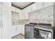 Bright laundry room with white cabinets and modern appliances at 20001 Gulf Blvd # 501, Indian Shores, FL 33785