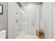 Modern shower with glass enclosure, pebble floor, and built-in seat at 20001 Gulf Blvd # 501, Indian Shores, FL 33785