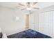 Bright bedroom with ceiling fan and double closets at 2964 Moulden Hollow Dr, Zephyrhills, FL 33540