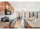 Kitchen with island, double sink, and view of dining area at 2964 Moulden Hollow Dr, Zephyrhills, FL 33540