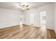 Bright and airy bedroom with wood-look flooring and access to bathroom at 36925 Kiowa Ave, Zephyrhills, FL 33542