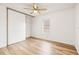 Simple bedroom with wood-look floors and ceiling fan at 36925 Kiowa Ave, Zephyrhills, FL 33542