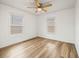 Spacious bedroom with wood-look floors and dual windows at 36925 Kiowa Ave, Zephyrhills, FL 33542