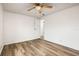 Bright bedroom with wood-look floors and ceiling fan at 36925 Kiowa Ave, Zephyrhills, FL 33542