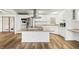 Modern kitchen with white cabinets, island and stainless steel appliances at 36925 Kiowa Ave, Zephyrhills, FL 33542
