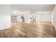Spacious living area with light wood flooring and ceiling fans at 36925 Kiowa Ave, Zephyrhills, FL 33542