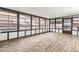 Bright sunroom with wood-look flooring and ample windows at 36925 Kiowa Ave, Zephyrhills, FL 33542