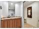 Vanity with granite countertop and wood cabinets in a secondary bathroom at 4951 Bacopa S Ln # 401, St Petersburg, FL 33715