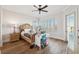 Bedroom with water views, hardwood floors, and a ceiling fan at 6015 Kipps Colony E Dr, Gulfport, FL 33707