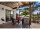 Relaxing screened porch with wicker furniture and canal view at 9386 Tradewinds Ave, Seminole, FL 33776