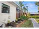 Landscaped side yard with walkway leading to the canal at 9386 Tradewinds Ave, Seminole, FL 33776