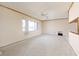 Bright living room featuring light walls, a ceiling fan, and ample space at 10215 3Rd E St, Treasure Island, FL 33706