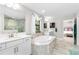 Main bathroom with soaking tub, walk-in shower, and double vanity at 14672 Horse Trot Rd, Lithia, FL 33547