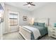 Cozy bedroom with a queen-size bed, nightstands and large window at 14672 Horse Trot Rd, Lithia, FL 33547