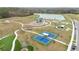 Aerial view of community amenities, including a playground and pickleball courts at 14672 Horse Trot Rd, Lithia, FL 33547