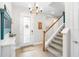 Bright and spacious entryway with staircase and decorative accents at 14672 Horse Trot Rd, Lithia, FL 33547