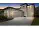 Two-story house exterior at dusk, two-car garage at 14672 Horse Trot Rd, Lithia, FL 33547